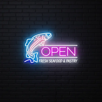 Fish Open neon sign with jumping fish and Fresh Seafood and Pastry text on a dark brick wall