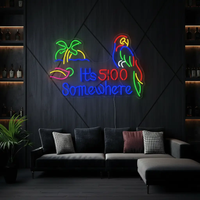It's 5:00 Somewhere neon sign with palm tree, cocktail and parrot glowing blue, green and red above a lounge sofa