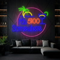 Round It's 5:00 Somewhere neon sign with palm tree and cocktail above a gray sofa