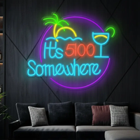 Round It's 5:00 Somewhere neon sign with palm tree and cocktail with teal lettering above a gray sofa