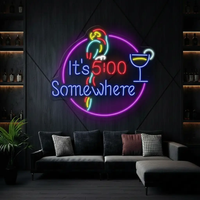 Round It's 5:00 Somewhere neon sign with parrot and cocktail above a gray sofa