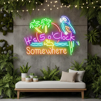 It's 5 O'Clock Somewhere neon sign with palm trees and parrot above a white bench with plants and string lights