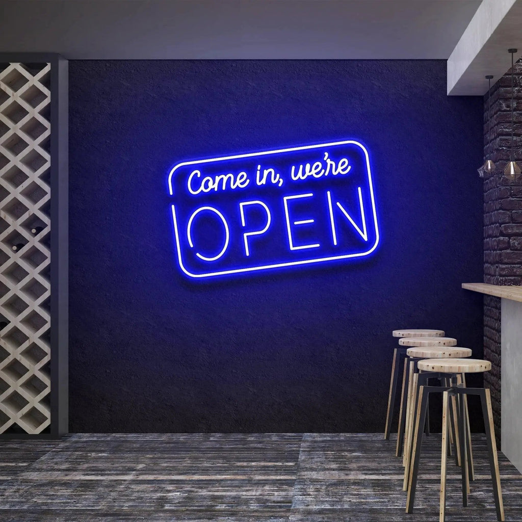 Come In We're Open neon sign glowing blue above bar stools