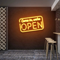 Come In We're Open neon sign glowing orange above bar stools